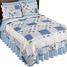 a blue and white quilted bedspread with matching pillow shams on it