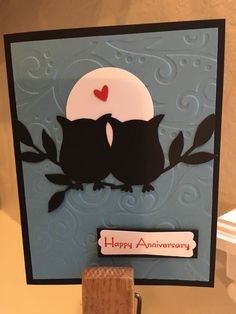 an anniversary card with two owls sitting on a branch