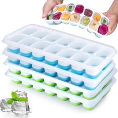 the ice tray is filled with different kinds of fruit and vegetables, while someone's hand reaches for it