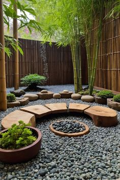 a garden with rocks and plants in the center, surrounded by bamboo trees on either side