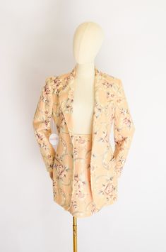 vintage 1990s mini skirt and jacket in a pale pink antique tapestry-inspired floral print. jacket has a long-line cut with hip and breast pockets and mother of pearl buttons. skirt zips up the back. both fully lined. label: The Limited, 60% linen, 40% cotton sizing: approx. xsmall -jacket- bust: 36" waist: 31" (when buttoned closed) shoulders: 16" length: 30" -skirt- waist: 25" hips: 35" length: 18" excellent condition. join us on IG @shop.fieldwork join the newsletter for new collection alerts + exclusive discounts Fitted Beige Outerwear With Floral Print, Fitted Beige Floral Print Outerwear, Feminine Fitted Skirt Suit For Spring, Fitted Floral Print Summer Blazer, Fitted Vintage Blazer With Floral Print, Vintage Fitted Floral Print Blazer, Fitted Vintage Floral Print Blazer, Antique Tapestry, Pink Antique