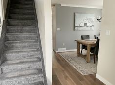 a staircase leading to a dining room and living room