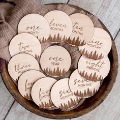 personalized wooden coasters with pine trees and the names of each month on them