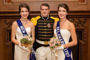 three people in formal dress posing for a photo