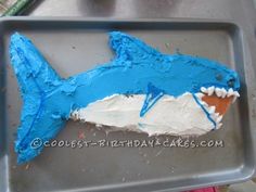 a cake shaped like a shark with blue icing