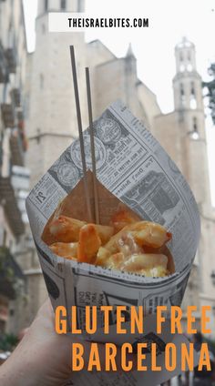 a person holding up a paper container with food in it and text reading gluten free barcelona