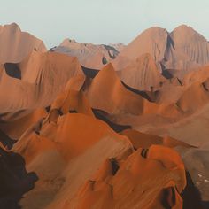 sand dunes with mountains in the background