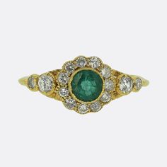 This is a wonderful emerald and diamond cluster ring crafted in 18ct yellow gold. The central emerald is a rich green hue and the surrounding diamonds are a bright white colour. Condition: Used (Very Good) Weight: 2.4 grams Ring Size: N 1/2 (54) Cluster Dimensions: 9.5mm x 9.5mm Emerald: Approx 0.50 carats Total Diamond Carat Weight: Approx 0.48 carats Diamond Colour: H-I Diamond Clarity: VS-SI Tested As: 18ct Yellow Gold Box: Plain gift box If you have any questions regarding my items, just sen Classic Green Cluster Diamond Ring, Classic Green Emerald Ring With Single Cut Diamonds, Classic Green Diamond Cluster Ring, Emerald Cluster Ring With Diamonds, Green Emerald Cluster Ring With Diamonds, Green Cluster Diamond Ring, Classic Green Cluster Ring With Brilliant Cut, Fine Jewelry Green Emerald Ring With Single Cut Diamonds, Classic Green Diamond Ring With Single Cut Diamonds