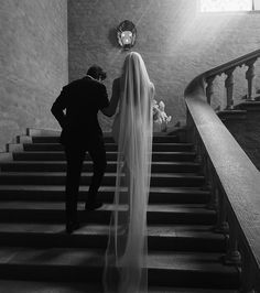 the bride and groom are walking down the stairs