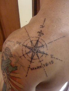 a man with a compass tattoo on his back