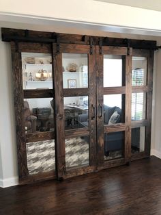 a living room with wooden floors and sliding glass doors