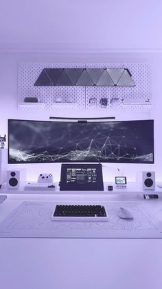 a white desk with a computer monitor and keyboard