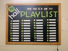 a sign that is on the wall in front of a bulletin board with playlist written on it