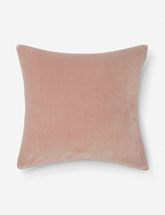 a pink velvet pillow on a white background with the word,'love is in the air