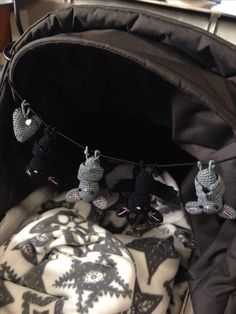 an open backpack with some little crocheted animals hanging from it