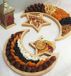 an assortment of dried fruits and nuts arranged in the shape of a crescent on a table