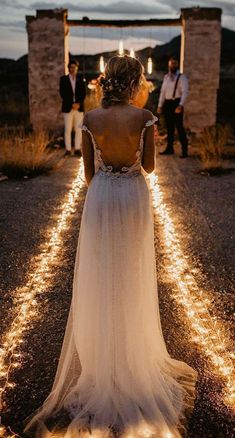 the back of a woman's dress as she walks down a path