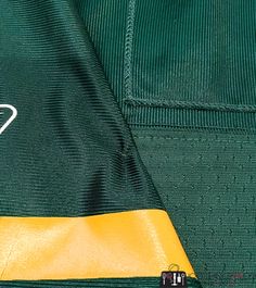 the green and yellow jersey has a white heart on it's left side pocket