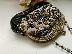 "This Victorian style reticule small evening purse will be a great accessory to your cocktail party dress, gala, formal event, living history festivals, Halloween flapper costume, and more! It will add a luxurious look to any evening look. The neutral colors allow you to match with various outfits. The black lace is over a champagne beige color underneath. The floral beading and details with rhinestones add a timeless elegant look. The kisslock closure top is made of metal designed to look like Elegant Clutch Evening Bag For Vintage Events, Handmade Victorian Evening Bag, Victorian Rectangular Party Bag, Victorian Rectangular Evening Bag For Party, Elegant Handmade Evening Bag For Vintage Events, Handmade Black Evening Bag For Wedding, Vintage Black Evening Bag For Party, Vintage Handmade Evening Bag For Party, Elegant Handmade Evening Bag