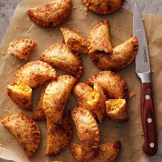 some food is laying out on a piece of paper with a knife next to it