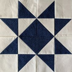 a blue and white quilted design with stars on it