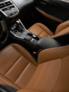 the interior of a car with tan leather and black trims, including steering wheel