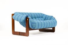 a chair that is made out of some kind of wood and blue fabric on it