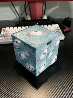 a cube shaped object sitting on top of a desk