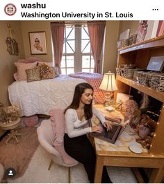 a woman sitting on a chair in front of a desk with a laptop and lamp