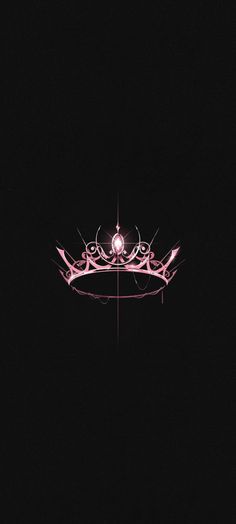 a crown is lit up in the dark with pink lights on it's sides