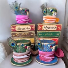 there are many hats that are stacked on top of each other and one has feathers