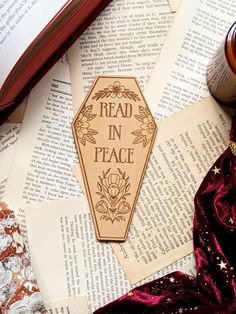 a bookmark that reads read in peace on top of an open book next to other books