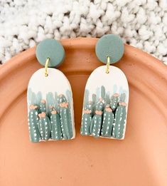 the cactus earrings are painted with acrylic paint