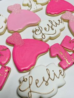 decorated cookies with pink and white frosting on a table