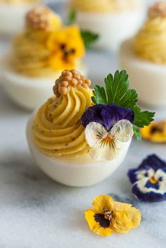 an assortment of desserts with flowers on them