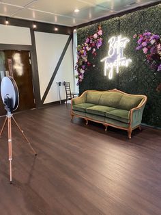 a living room filled with furniture and flowers on the wall next to a wooden floor