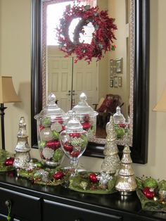 christmas decorations on a dresser in front of a mirror