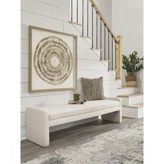 a white bench sitting in front of a stair case