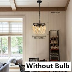 a living room filled with furniture and a chandelier hanging over the top of it