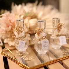 three perfume bottles sitting on top of a wooden table