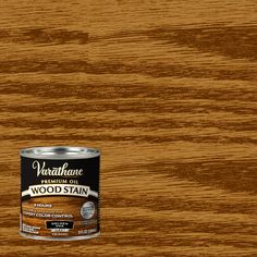 a can of wood stain sitting on top of a wooden table