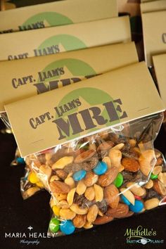 three bags filled with nuts and candy on top of a black tablecloth covered table