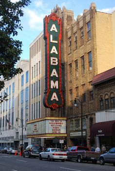 a large sign on the side of a building that says alhama in red and green