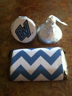 two candy bags, one wrapped in blue and white chevron fabric, the other decorated with silver foil