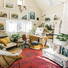 a living room filled with furniture and lots of pictures on the wall above it's windows