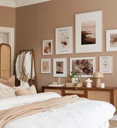 a bed sitting in a bedroom next to pictures on the wall