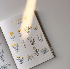 a white book with yellow flowers on it