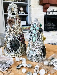 two decorative objects sitting on top of a wooden table next to a fire place filled with candles