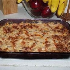 a casserole dish with bananas and cherries in the background