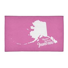 a pink towel with the state of maine on it and white lettering that reads, home sweet juneau